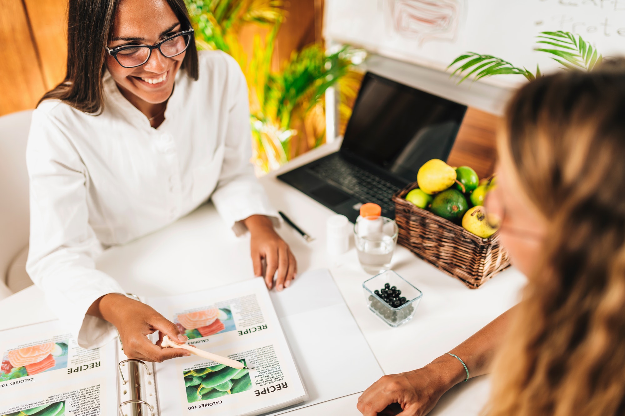 Nutritionist and Client Discussing Balanced Nutrition Plan